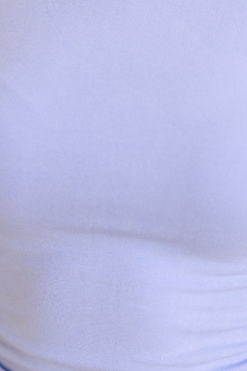 Close-up of soft, stretchy cotton fabric in light blue for the Zira Top, featuring a smooth texture and lined design.