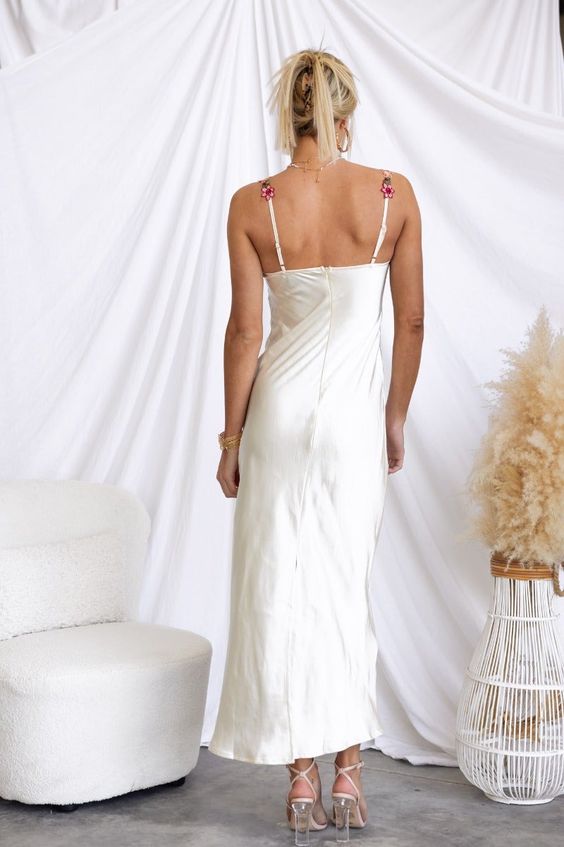 Back view of the Fairy Dust Maxi Dress, satin fabric with embroidered floral straps, model showing elegant silhouette.
