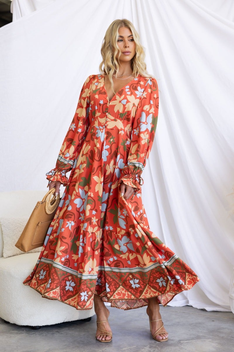 Floral print Taniah Maxi Dress featuring V-neckline, elastic cuffs, and a flowing design, perfect for summer events.