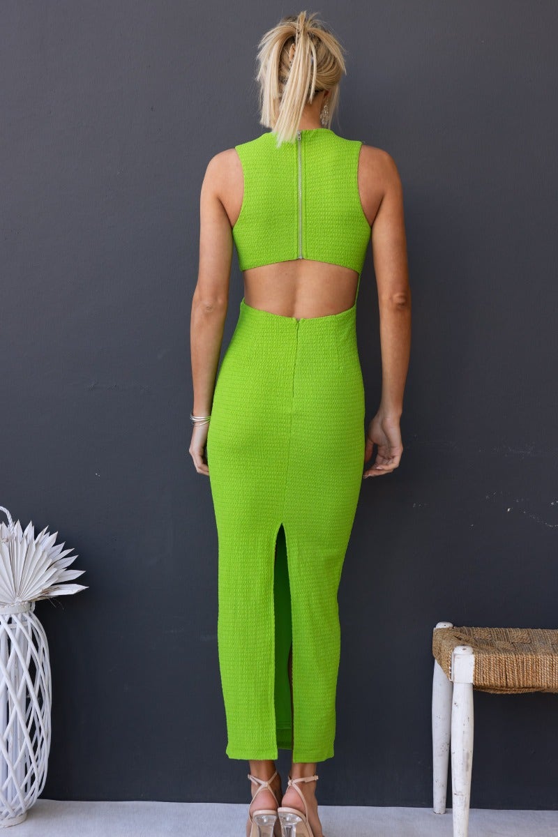 Back view of a textured green Yves Maxi Dress featuring a high neckline and stylish cut-out at the waist.