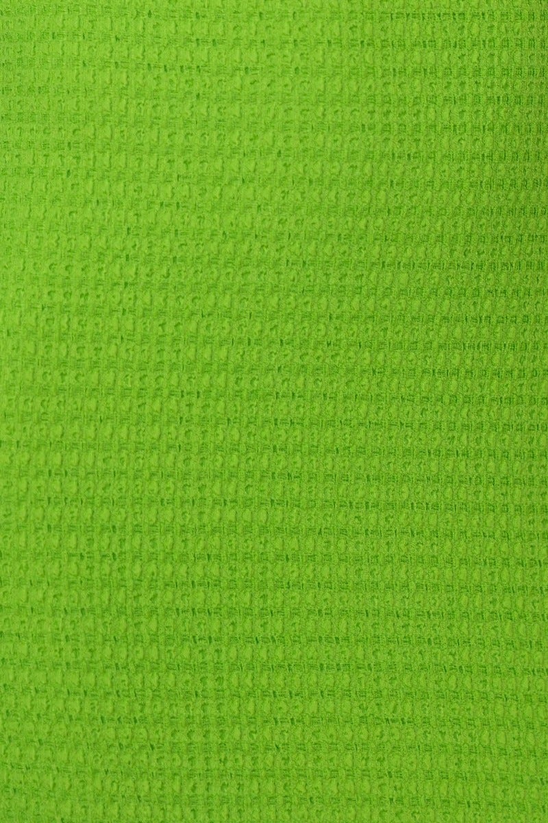 Textured green fabric close-up, showcasing a vibrant hue ideal for a maxi dress design.