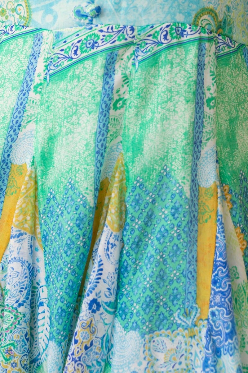 Close-up of the Forever Glow Dress featuring vibrant multi-colour patterns and intricate detailing on the skirt fabric.
