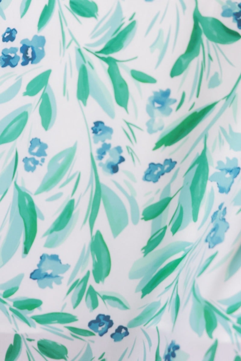 Floral pattern featuring blue flowers and green leaves on a white background, perfect for a stylish midi dress.