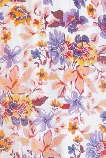Close-up of floral print fabric featuring vibrant flowers in pink, purple, and orange tones on a white background.