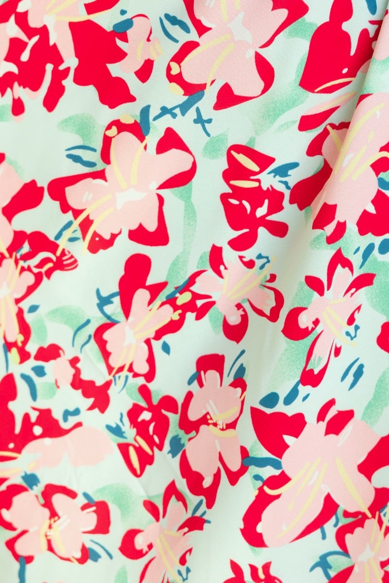 Floral print fabric detail featuring pink and red flowers on a light green background for Ronan Maxi Dress.