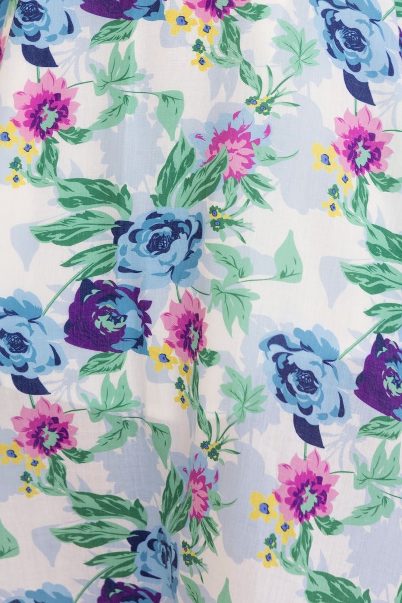 Close-up of floral fabric pattern featuring blue roses and pink flowers for the Rekiah Midi Dress.