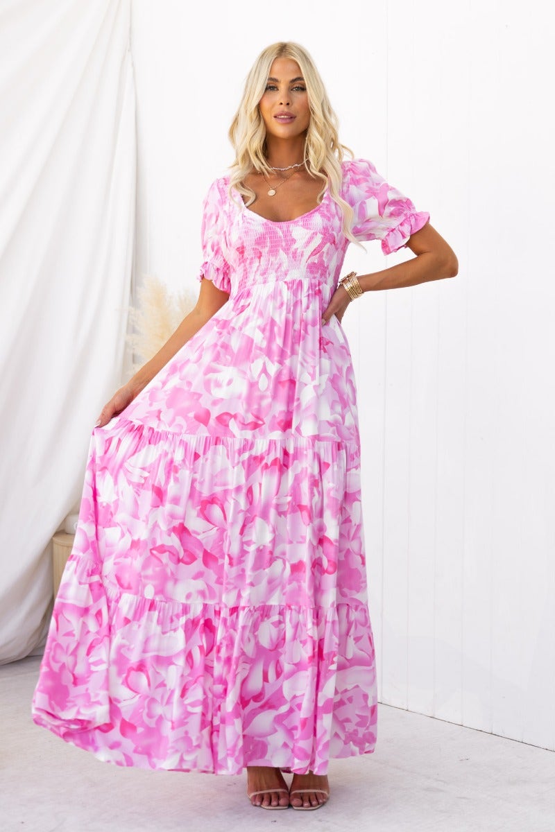 Floral print Sheridan maxi dress with V-neckline, elastic bodice, and full skirt in pink shades.
