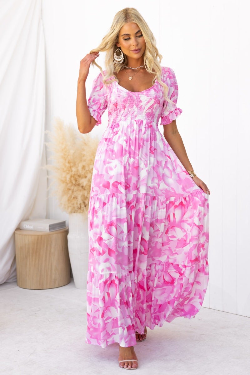 Floral print pink maxi dress with V-neckline and elastic bodice, perfect for summer occasions.