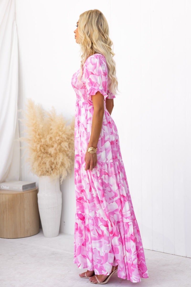 Side view of the Sheridan Maxi Dress in floral print, featuring a V-neckline and elastic bodice.