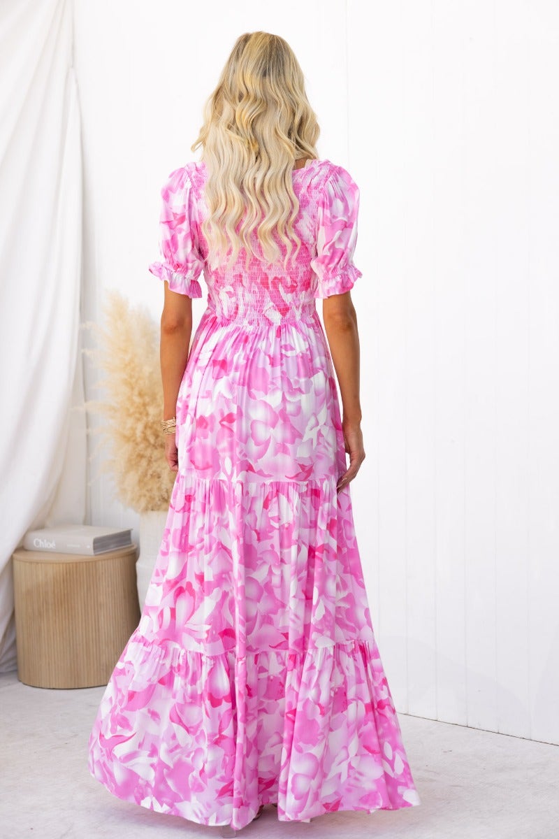 Back view of a floral print Sheridan maxi dress featuring a V-neckline and elastic bodice, perfect for summer style.
