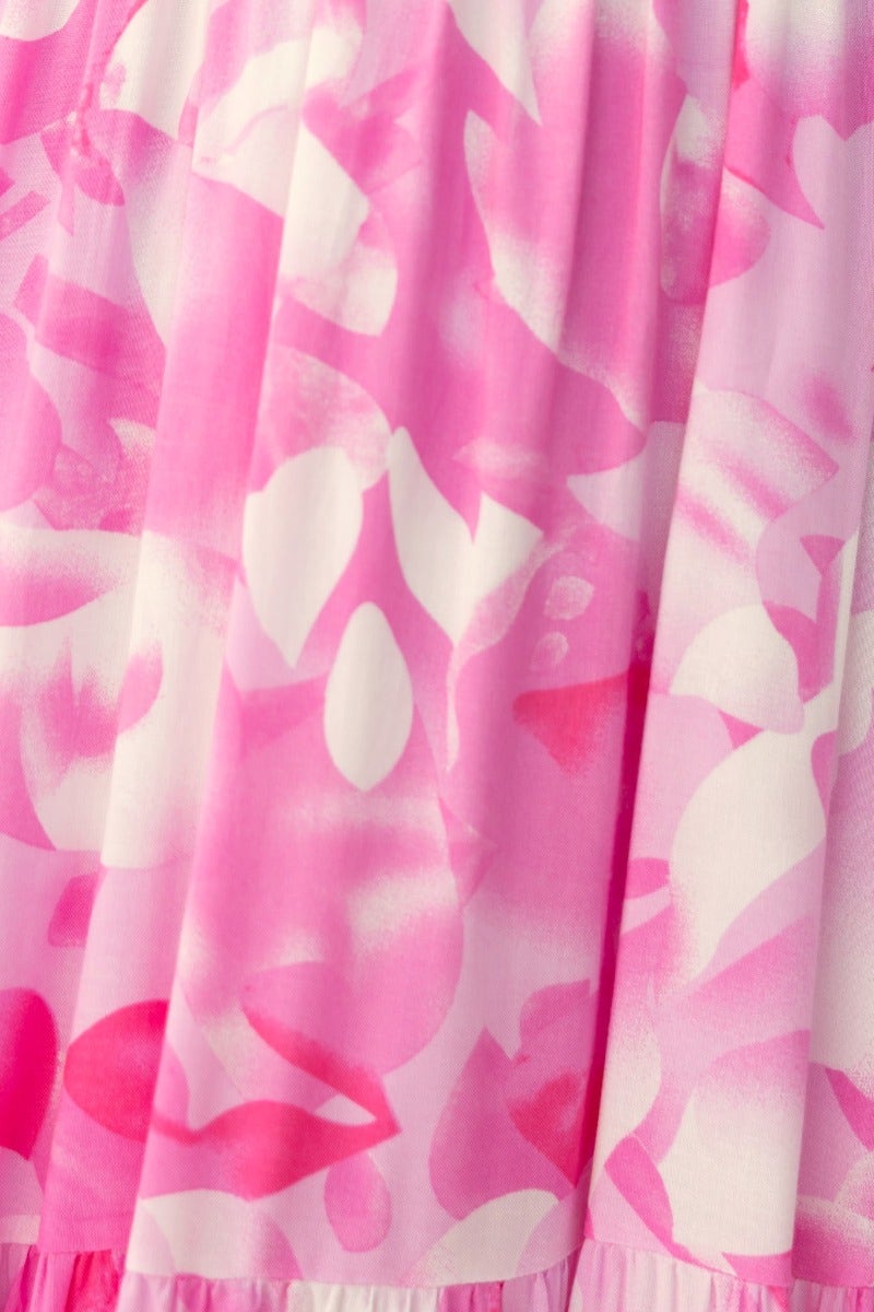 Close-up of pink floral print fabric, showcasing vibrant colors and soft texture of Sheridan Maxi Dress.
