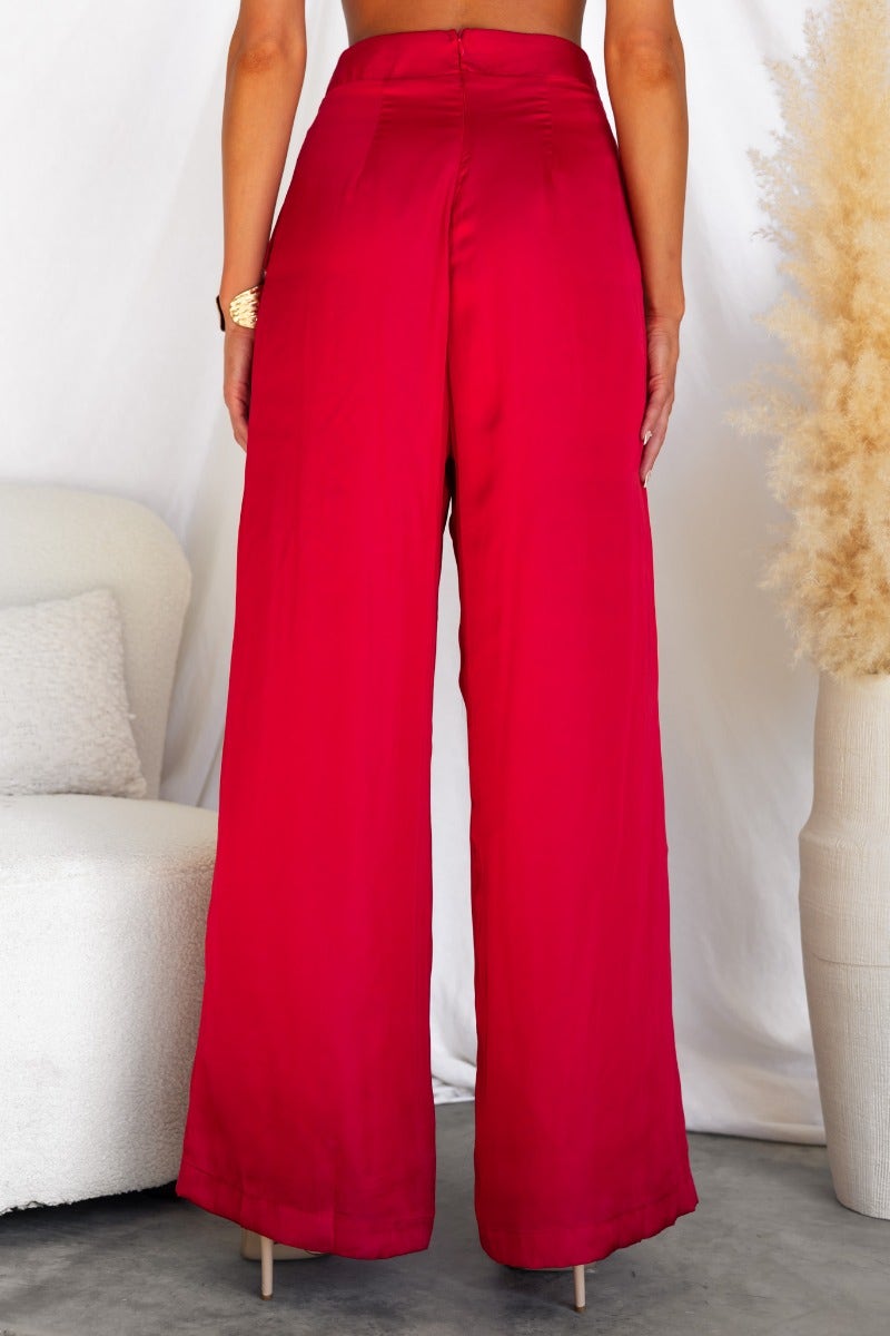 Back view of Show Stopper Pants in red satin, featuring wide legs and an invisible zip detail.