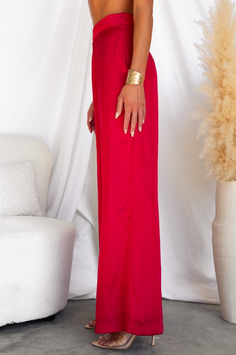 Show Stopper Satin Pants in vibrant red, featuring wide legs, pockets, and a stylish invisible back zip.