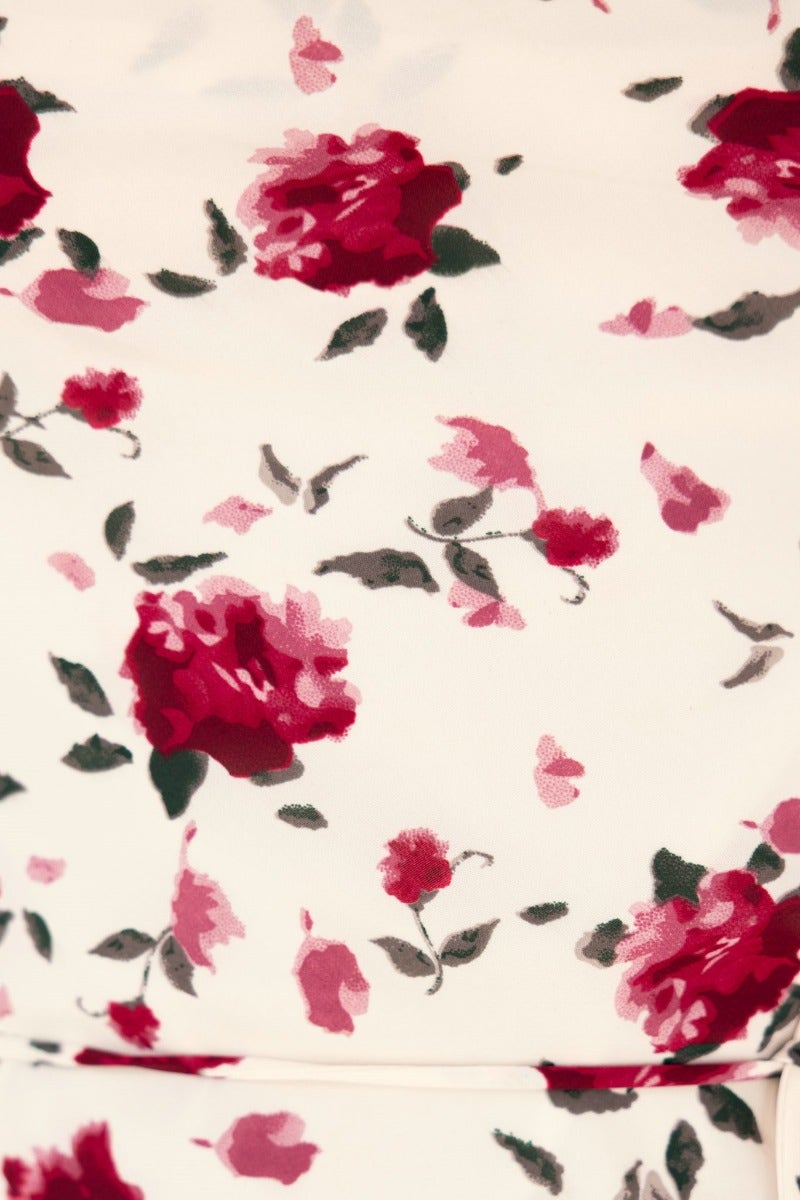 Floral print fabric detail of Love Language Maxi Dress featuring pink and red roses on a cream background.