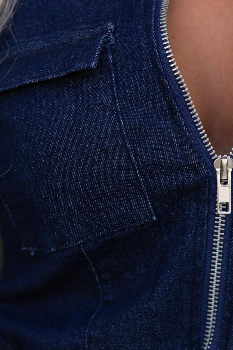 Close-up of Cobain denim playsuit featuring front zip and bust pocket, showcasing the fabric texture and design details.