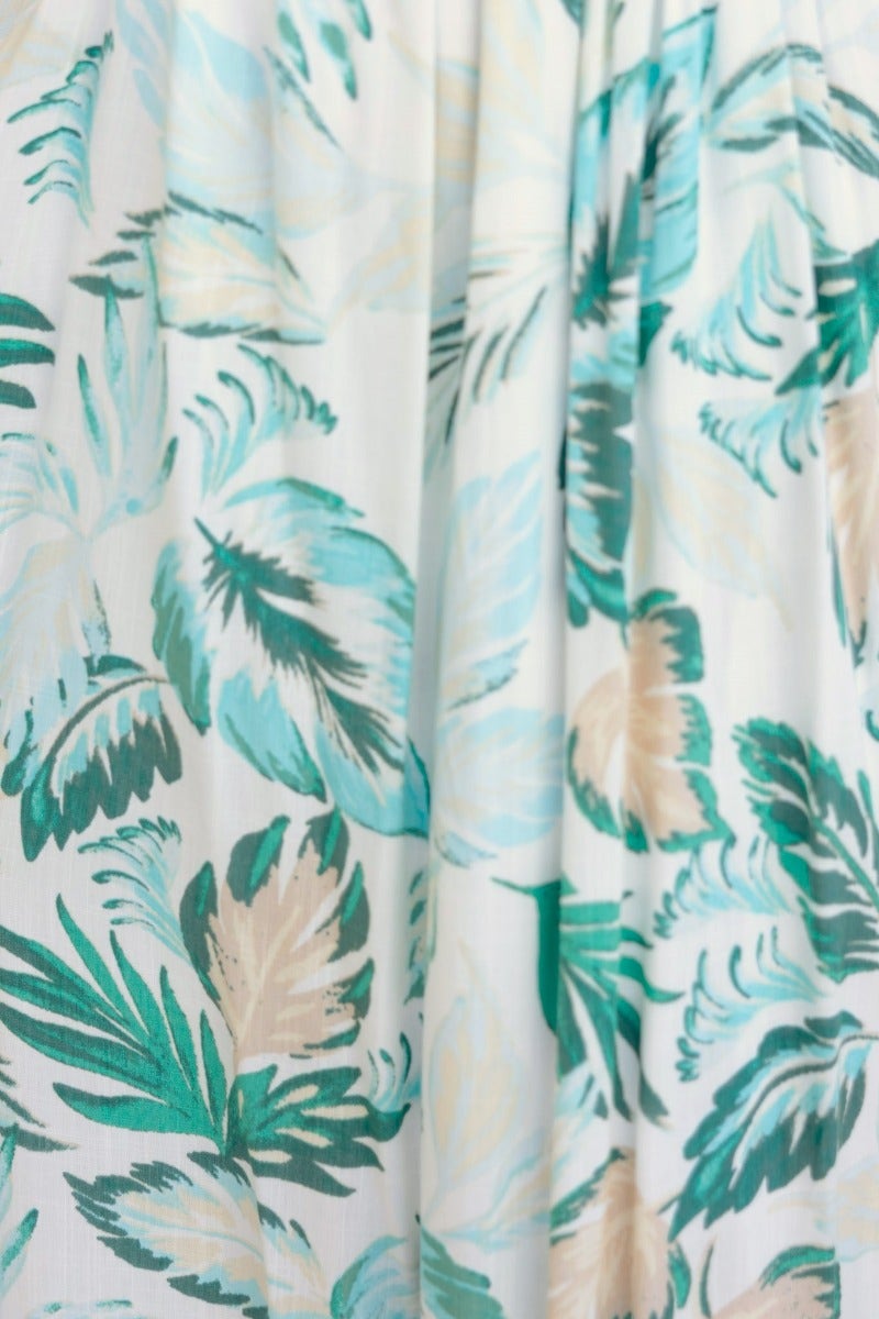 Close-up of floral print fabric in teal, beige, and white for the Out Of Sight Maxi Dress.