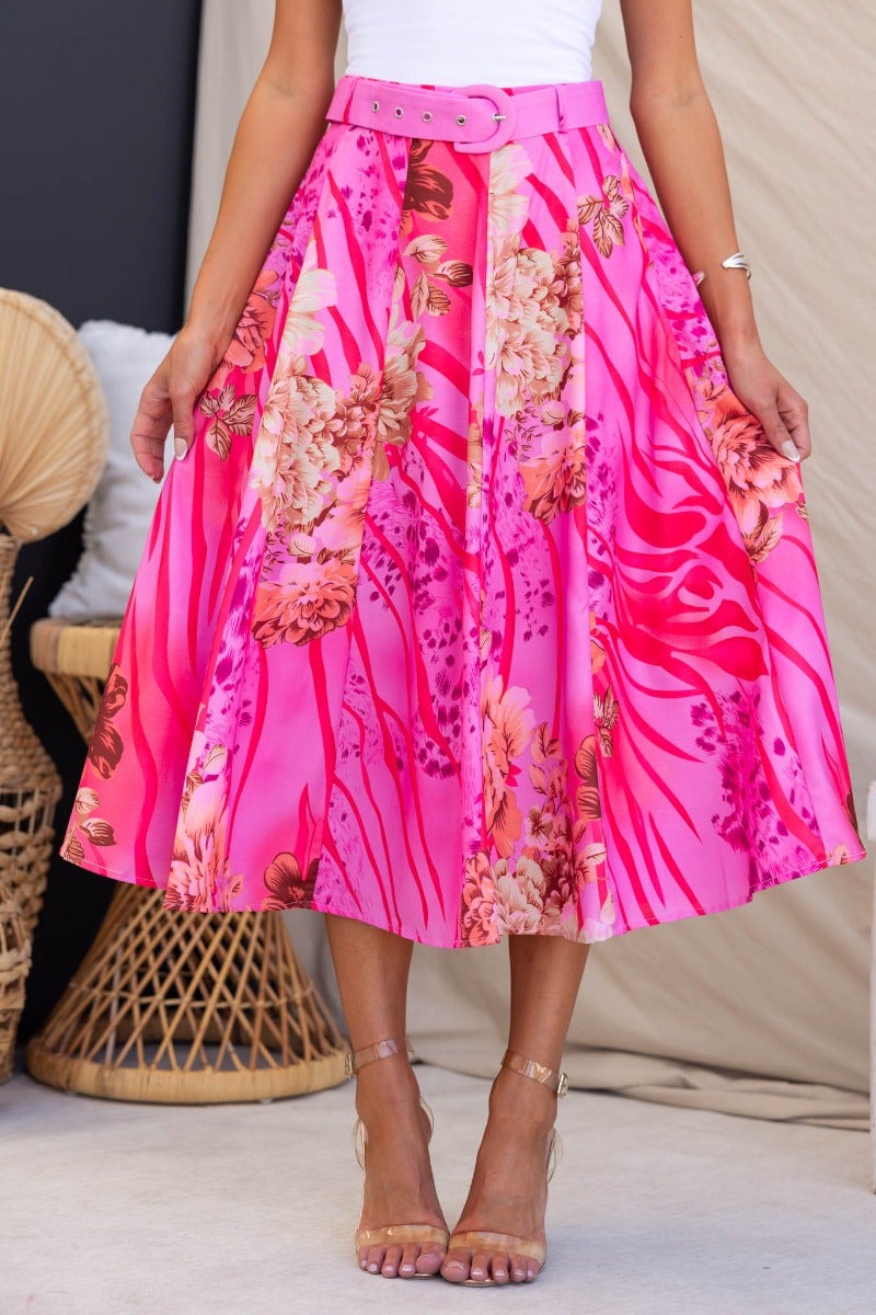 Floral print optimistic midi skirt in vibrant pink with removable belt, showcasing a mid-high waist fit and elegant flow.