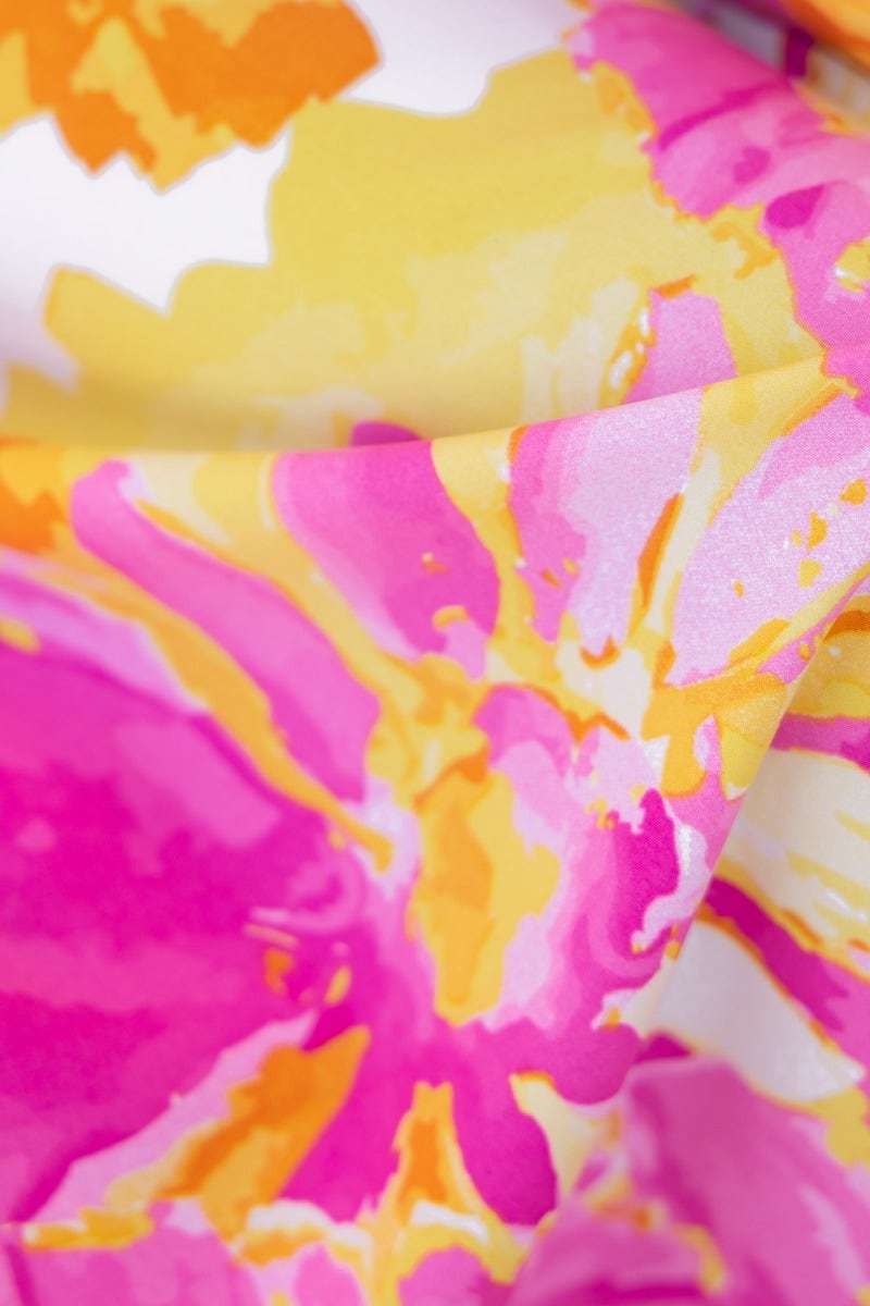 Close-up of vibrant pink and yellow floral print fabric, perfect for the Ivy Jumpsuit design.