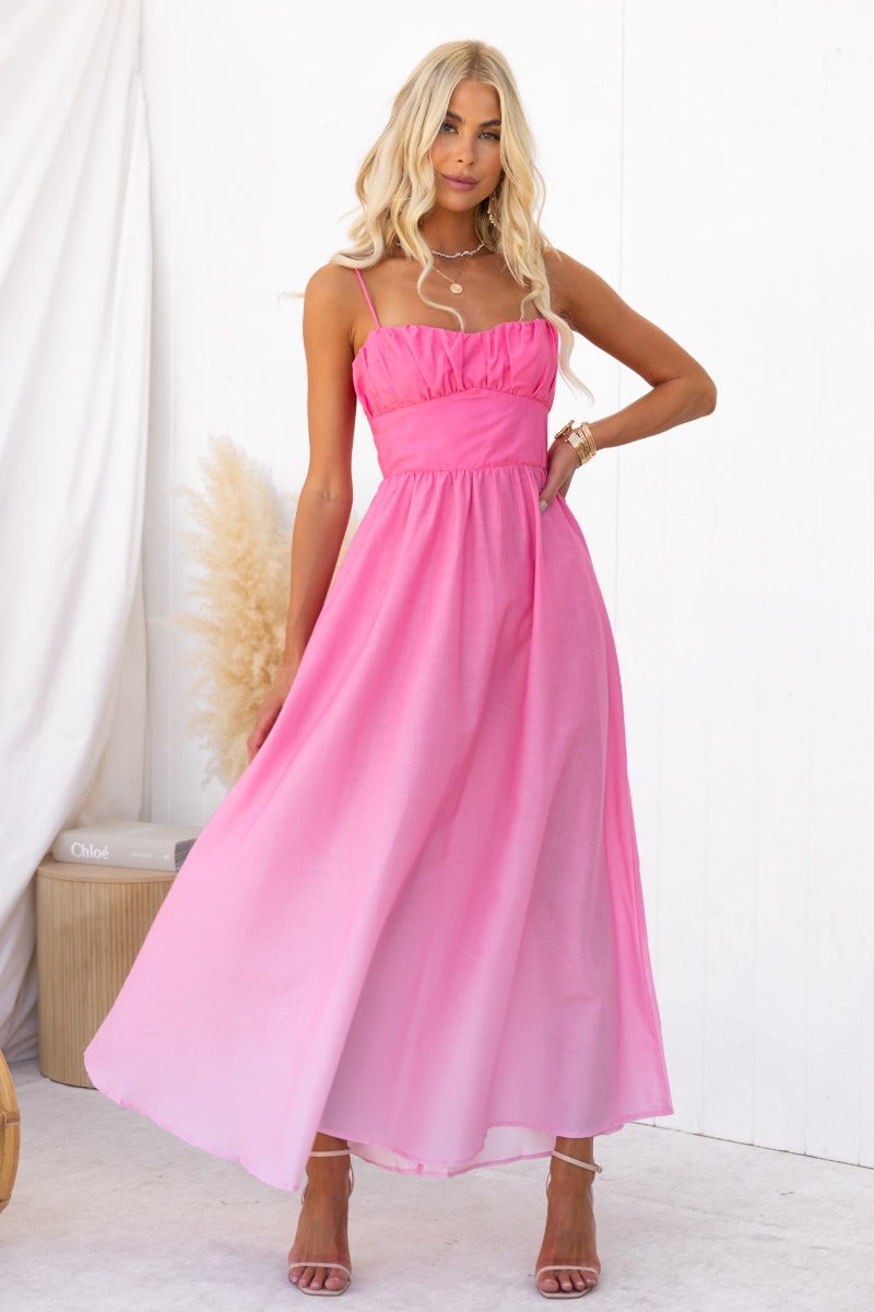Model wearing a pink Blank Space maxi dress with adjustable straps and a flowing design, perfect for summer occasions.
