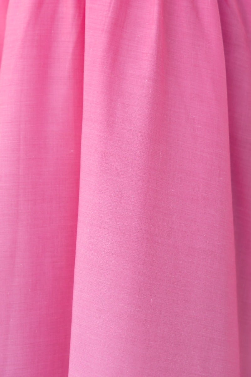 Close-up of a soft, pink fabric texture of a maxi dress, showcasing its lightweight and breathable material.