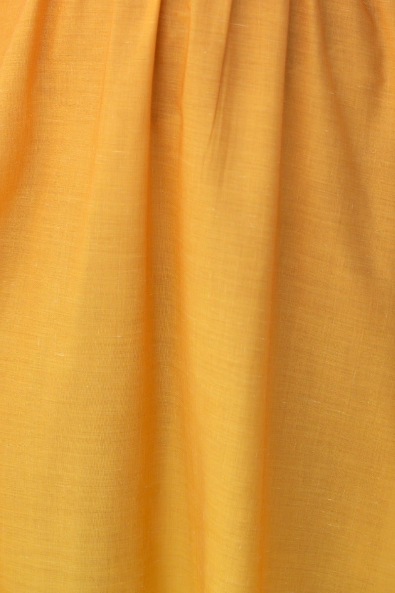 Close-up of soft, flowing yellow fabric, showcasing texture of the Cotton blend material used in the Blank Space Maxi Dress.