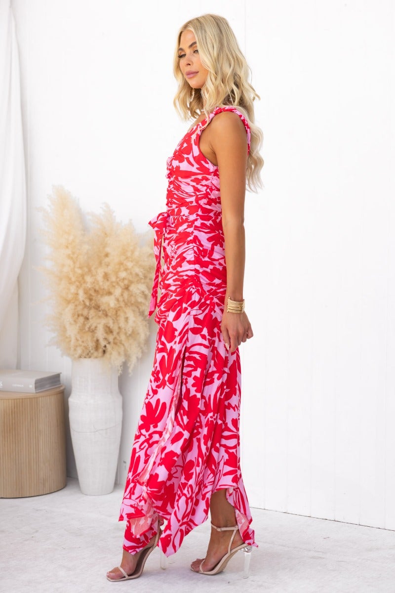 Floral print Escoda Maxi Dress featuring one-shoulder neckline, ruching, asymmetrical hem, and side split, styled elegantly.