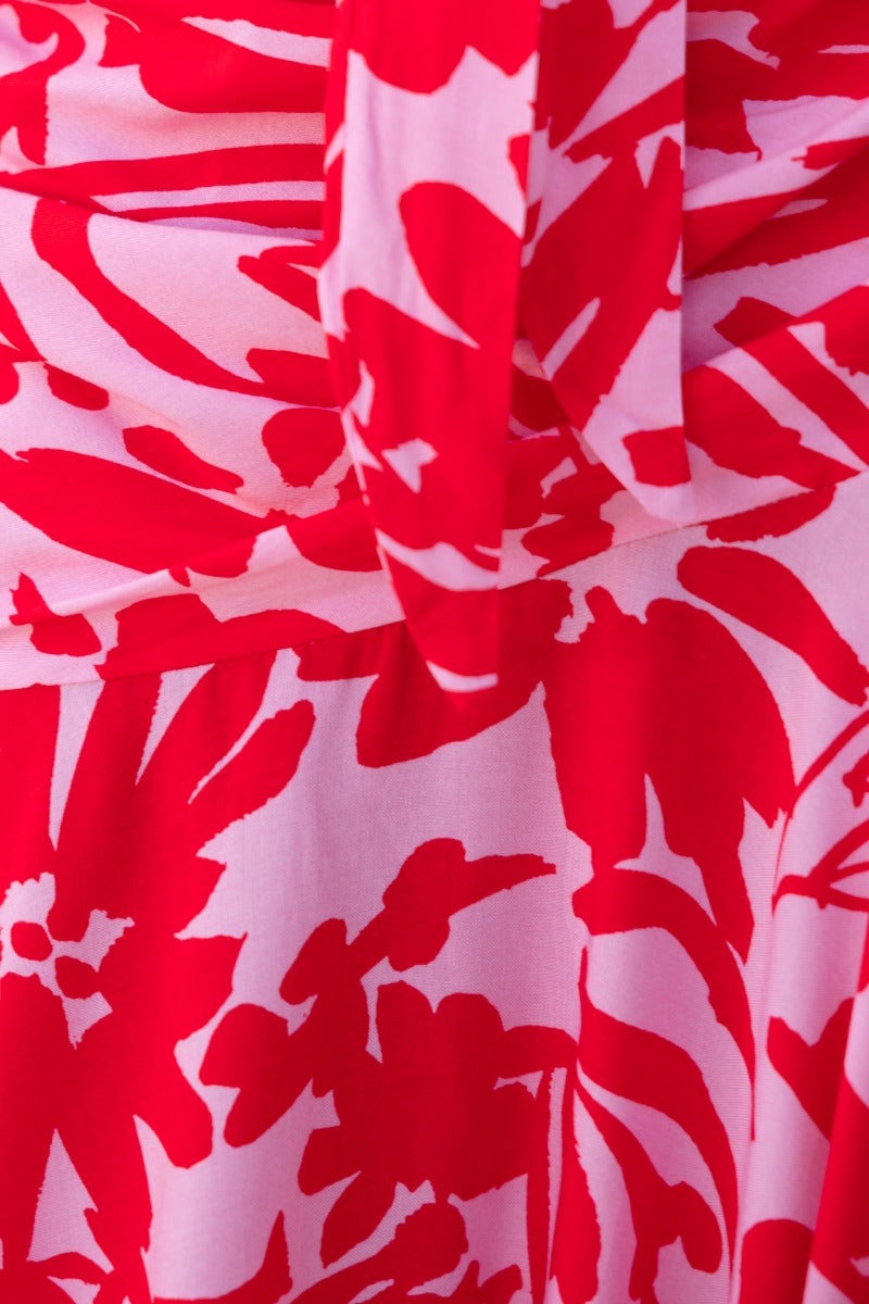 Close-up of floral print in vibrant red hues on Escoda Maxi Dress fabric, showcasing the material's texture and design.