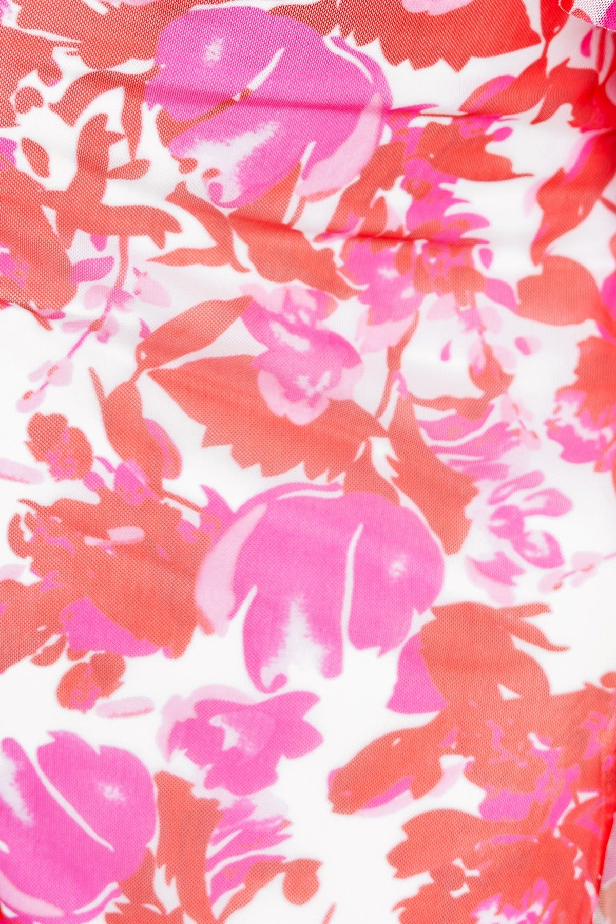 Close-up of vibrant floral print in pink and red on a Jillian Maxi Dress, featuring soft, colorful patterns.