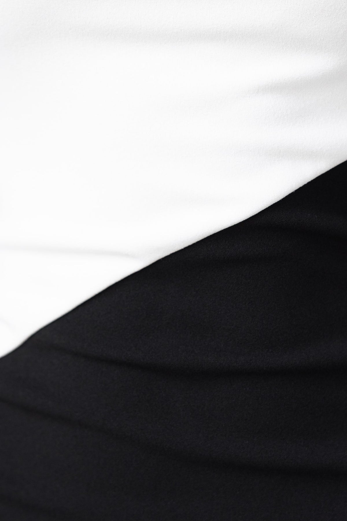Close-up of the Dezi Maxi Dress showcasing black and white fabric sections with smooth, stretchy texture.