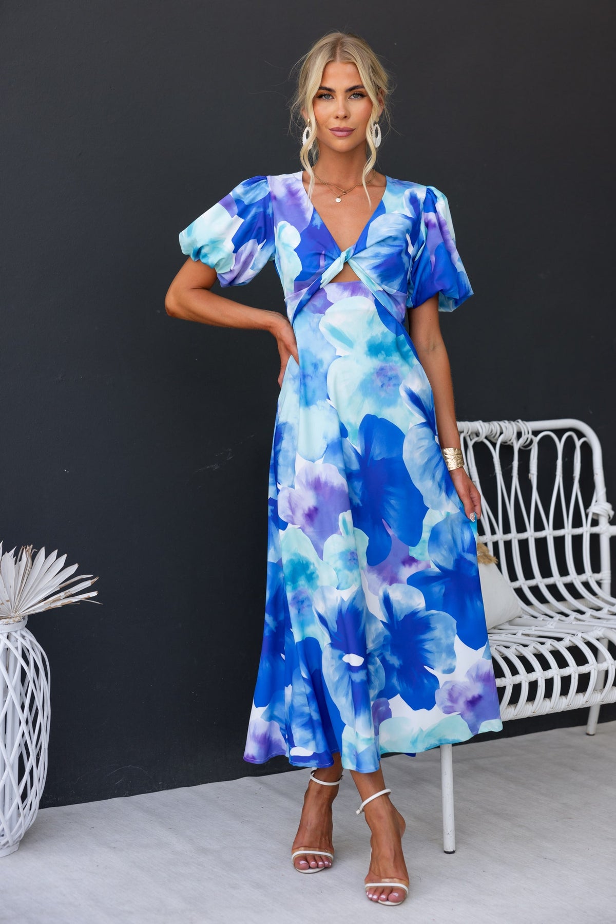 Qeilor Midi Dress in blue floral print, featuring a V-neckline, cut-out under bust, and elastic sleeves.