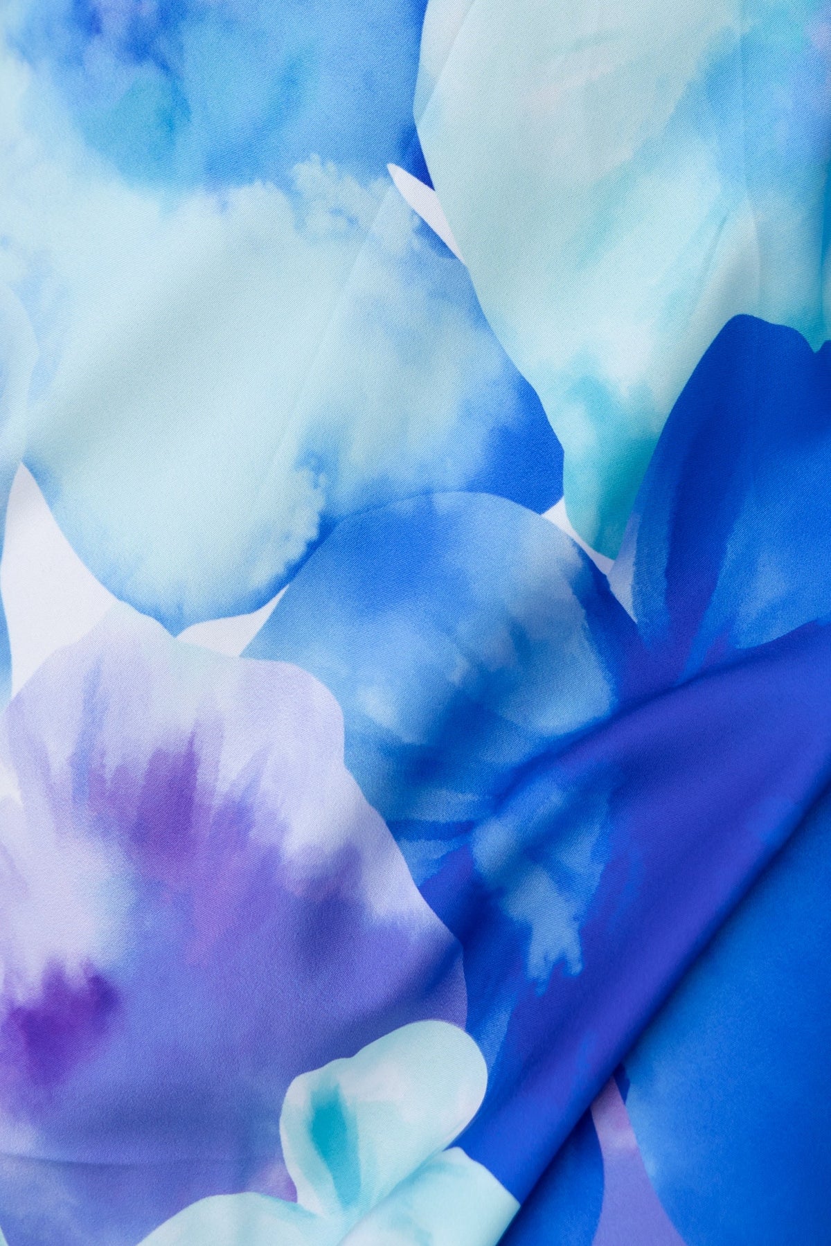 Close-up of vibrant floral fabric in shades of blue and purple, ideal for the Qeilor Midi Dress design.