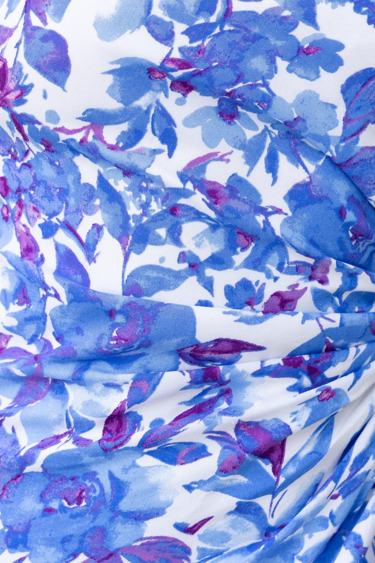 Close-up of floral print on Ronan Maxi Dress featuring blue and purple hues with adjustable ruching details.