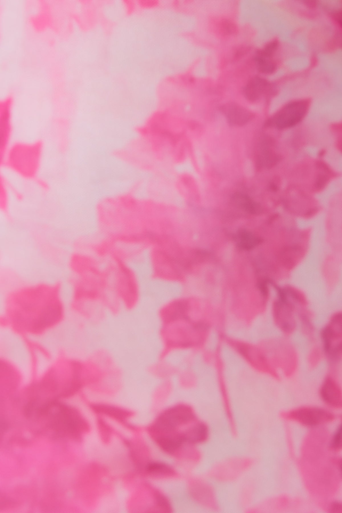 Floral print fabric in shades of pink, featuring soft, blurred rose motifs, ideal for summer dresses.