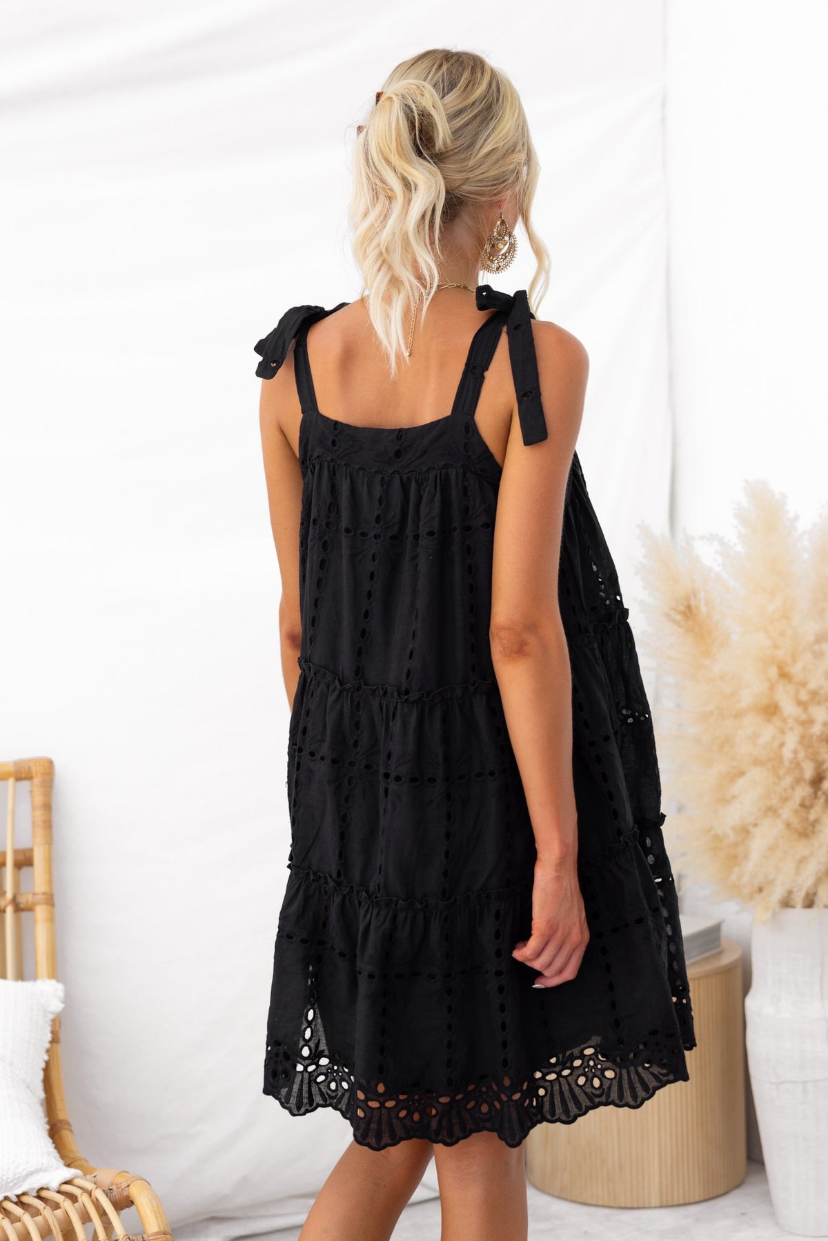 Charlene Dress in black with adjustable tie straps, featuring Anglaise material and a relaxed fit.