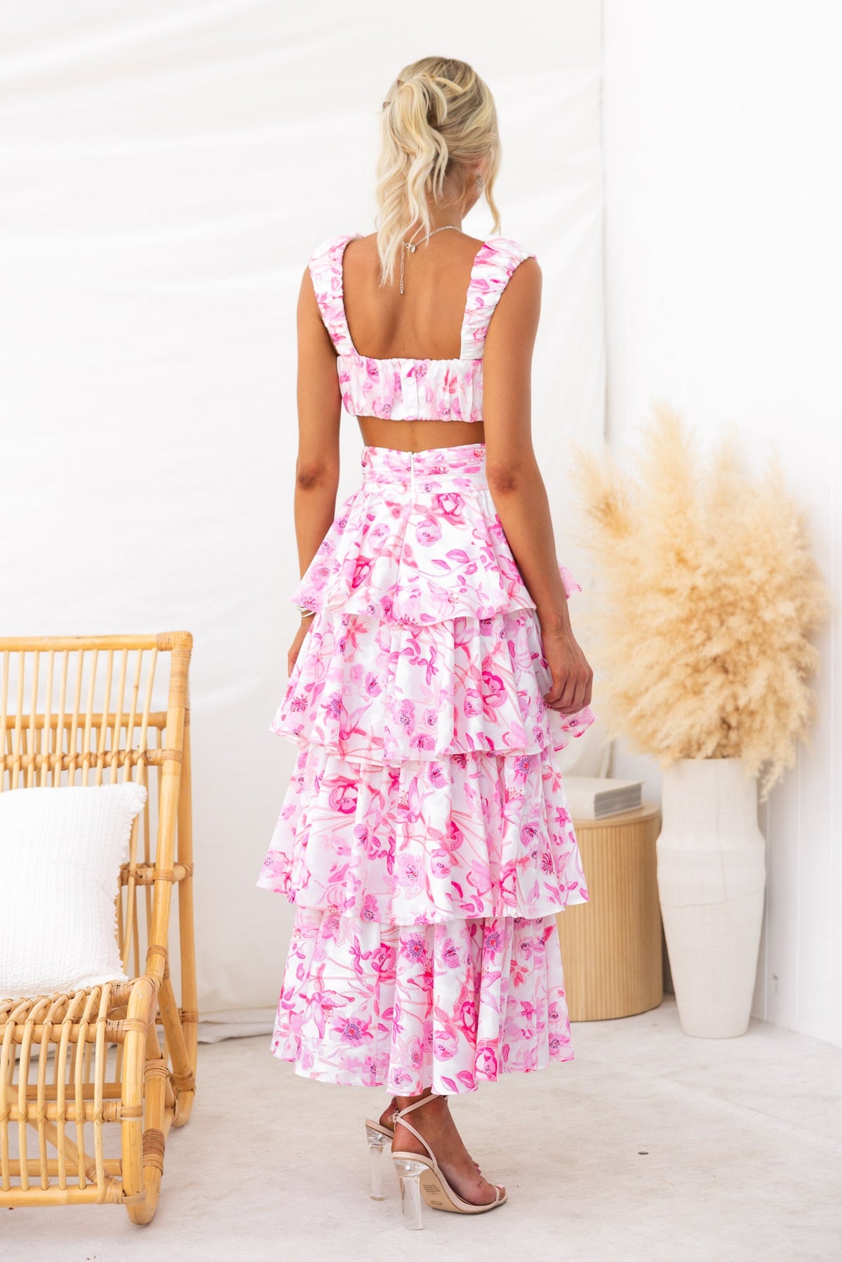 Back view of a floral print Illusion Set with ruffled maxi skirt and cropped top in pink, perfect for summer outings.