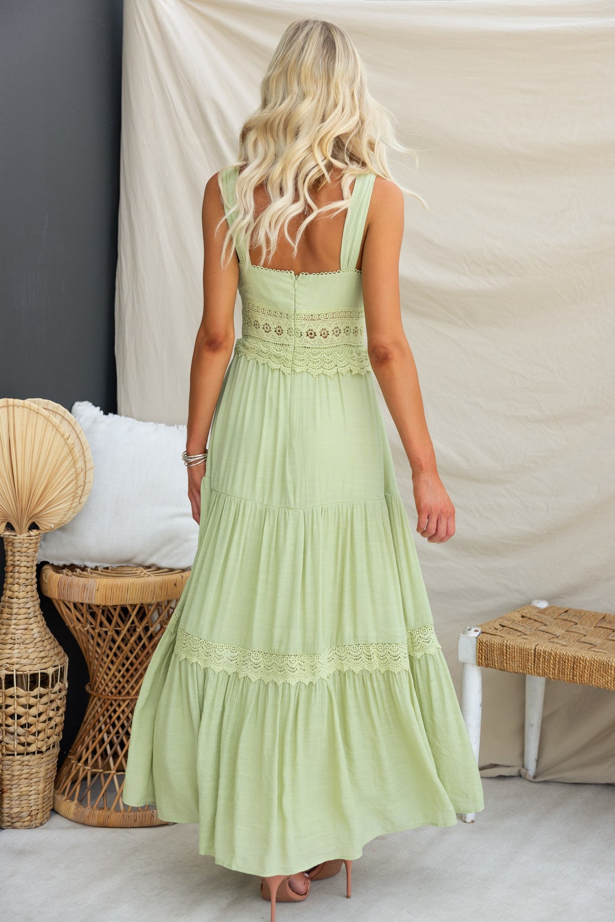 Back view of Flaria Maxi Dress in light green with lace detail and tiered skirt, showcasing a flowy design and comfortable fit.