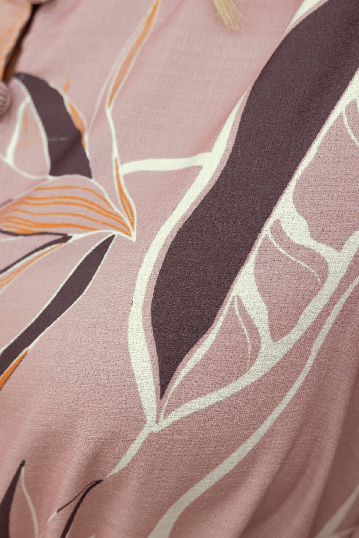 Close-up of floral pattern on Jubell Midi Dress, featuring soft pink tones and elegant leaf designs.