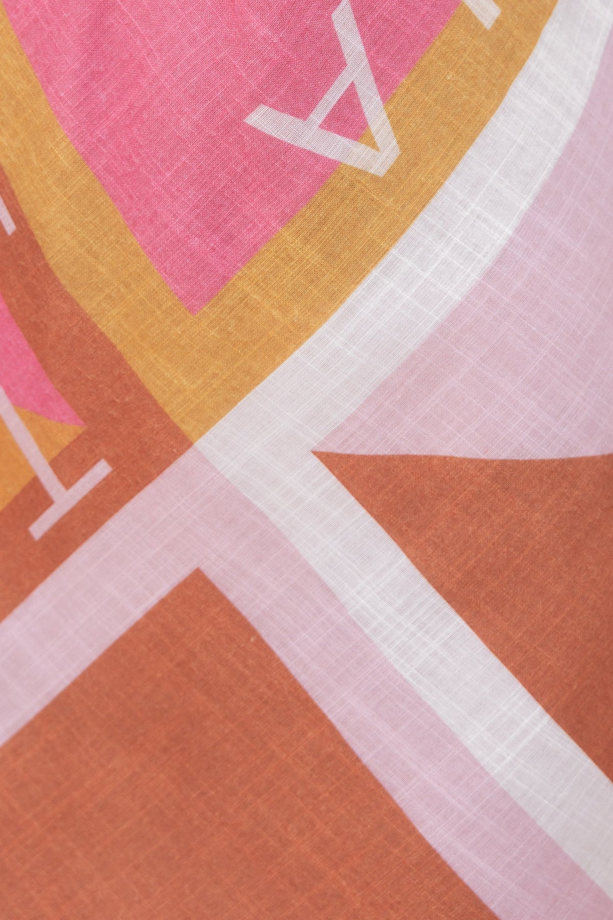 Close-up of colorful print fabric featuring pink, yellow, and brown hues for Jovie Maxi Dress, showcasing its unique design.