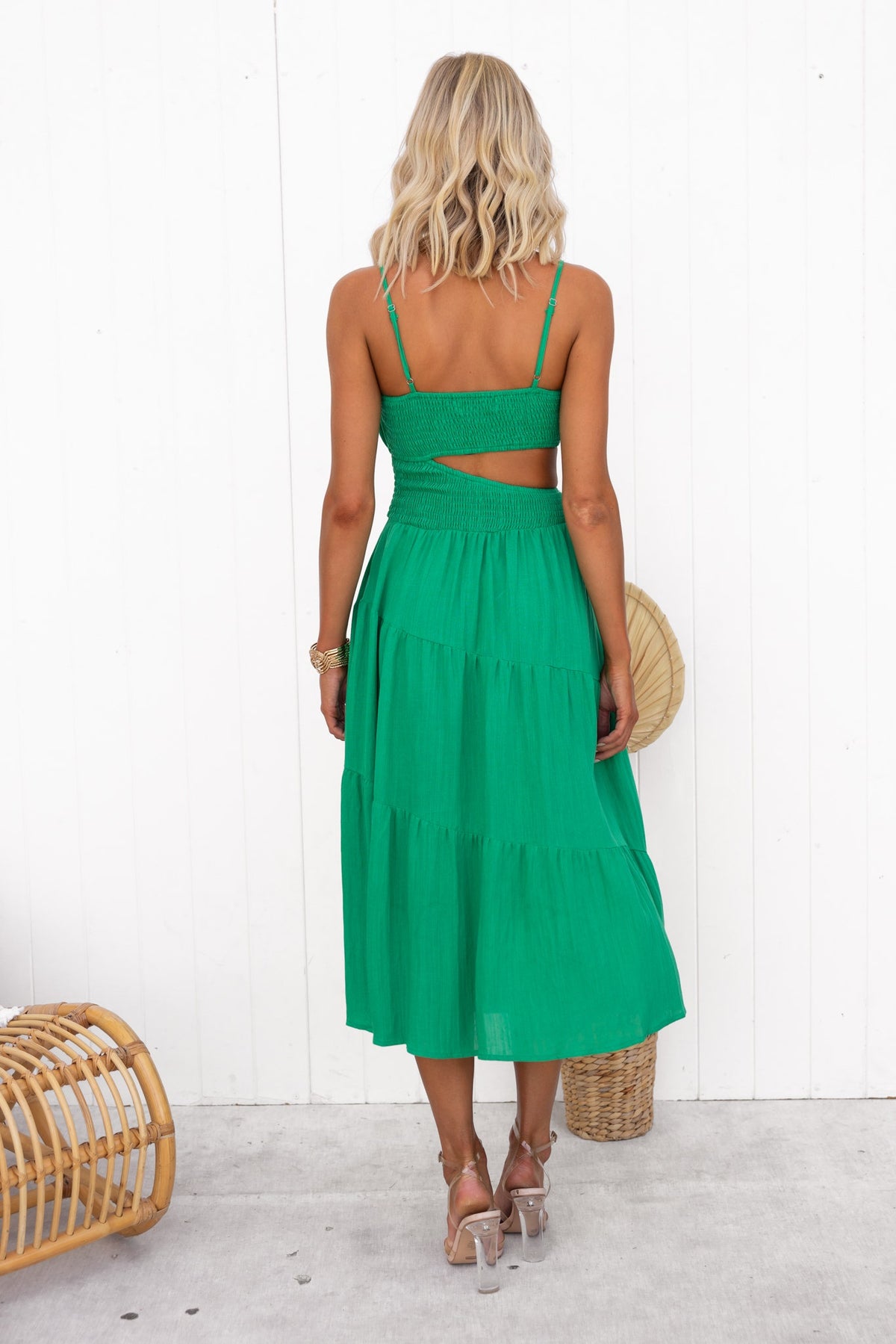 Back view of a woman in a green Panama Midi Dress, featuring adjustable straps and a cut-out design.