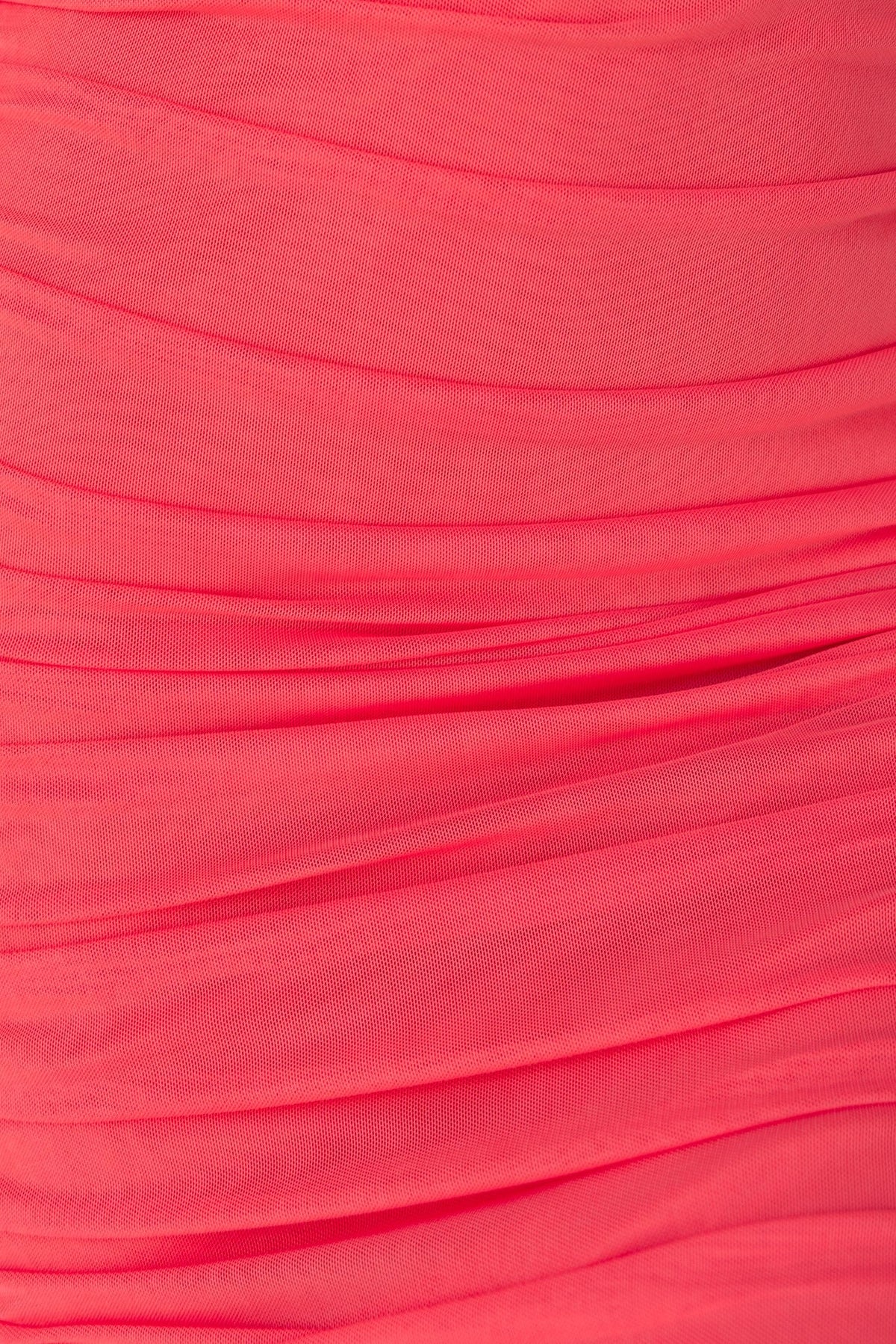 Close-up of coral mesh fabric featuring elegant ruching, ideal for a stylish midi dress design.