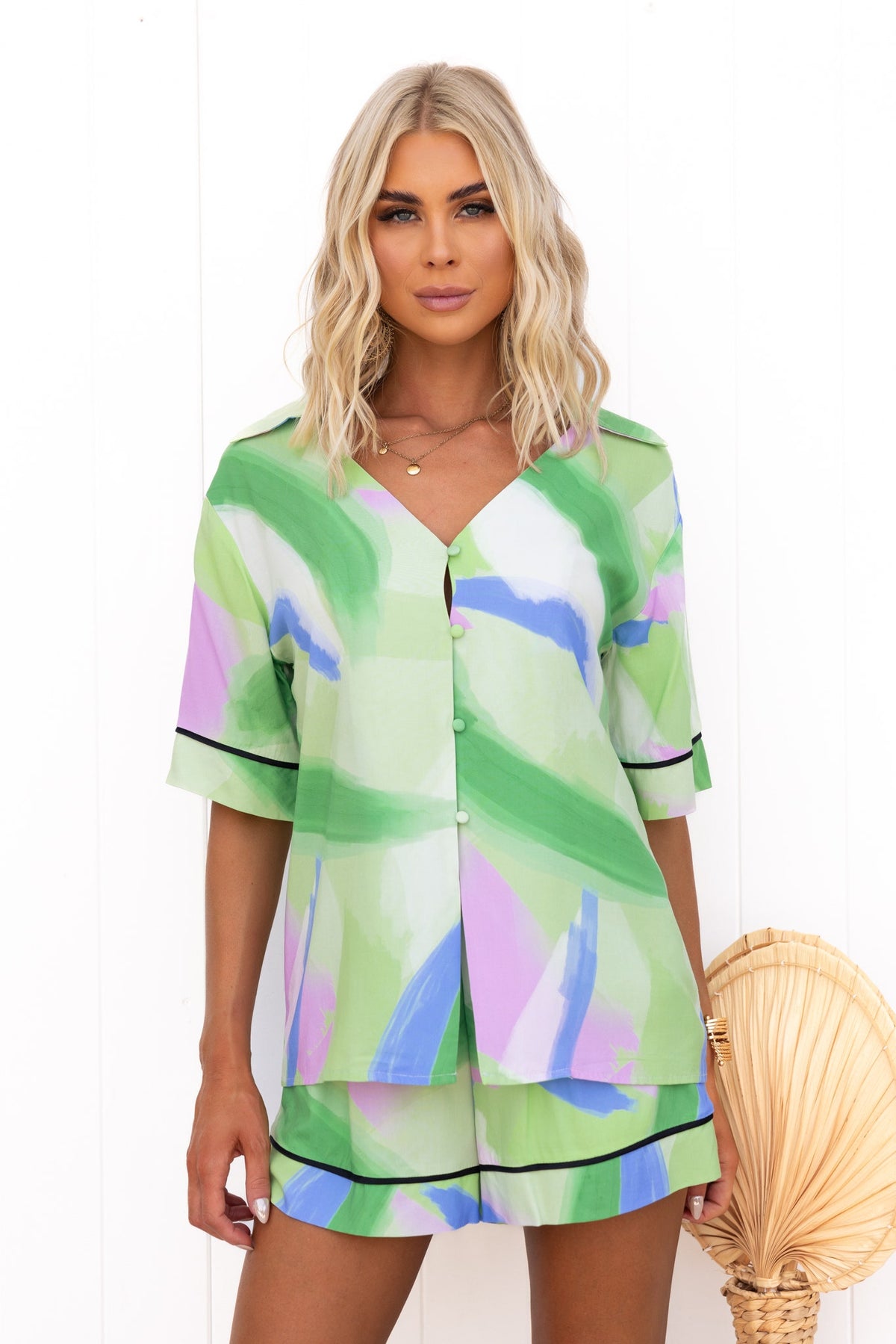 Model wearing the Focus Shirt, a stylish print button-up in green, blue, and purple, features a relaxed fit.