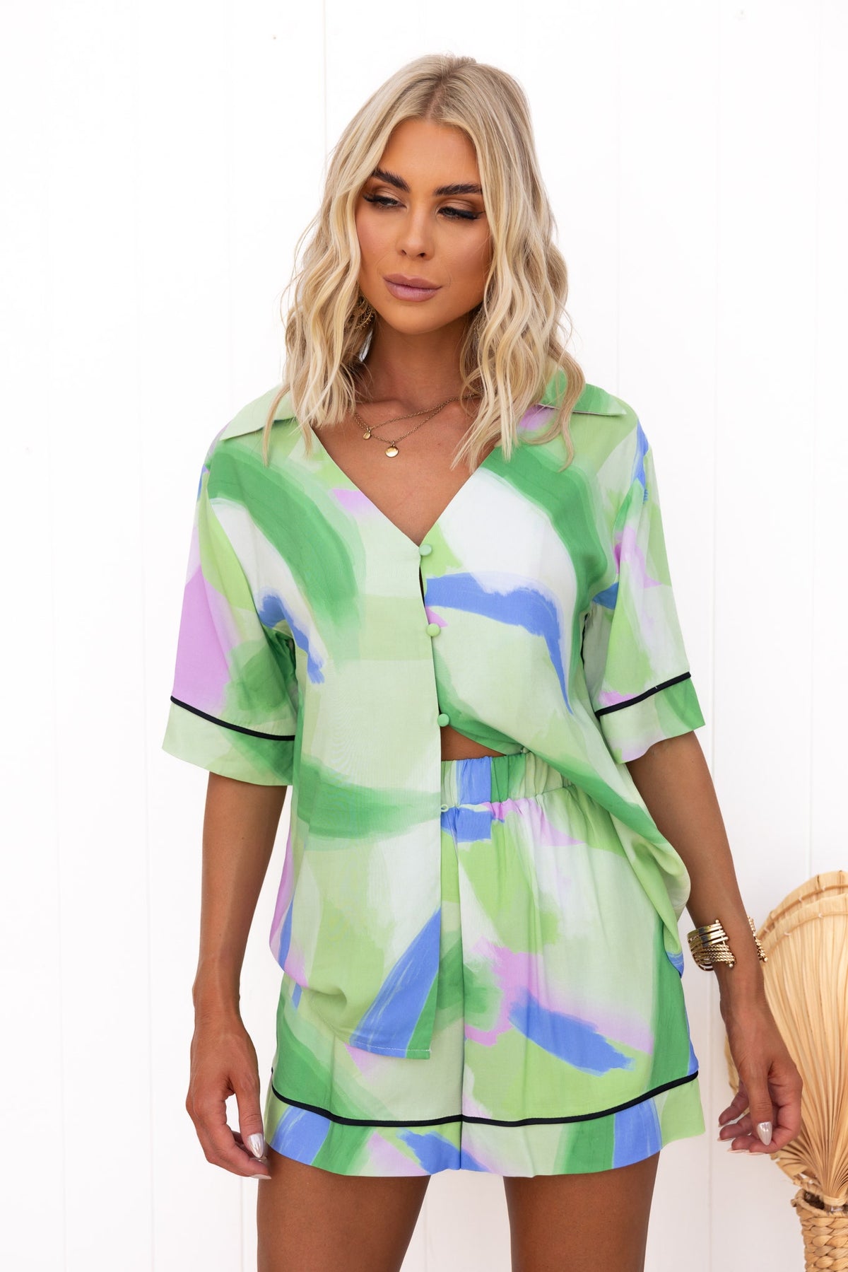 Model wearing green print Focus Shorts and matching top, showcasing stylish casual summer wear.