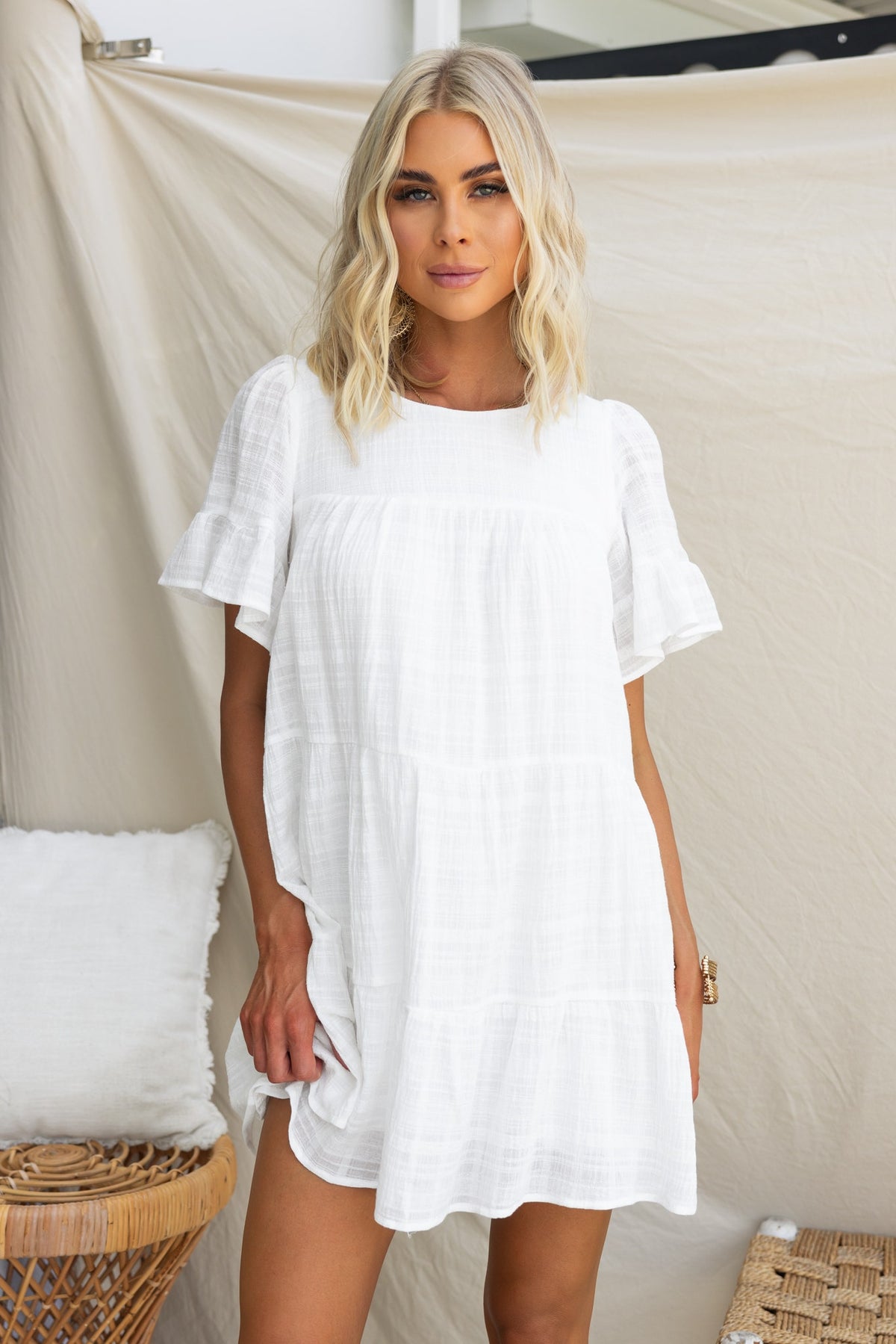 Parker Dress in white, featuring short sleeves and a relaxed fit, styled with elegant, textured fabric.