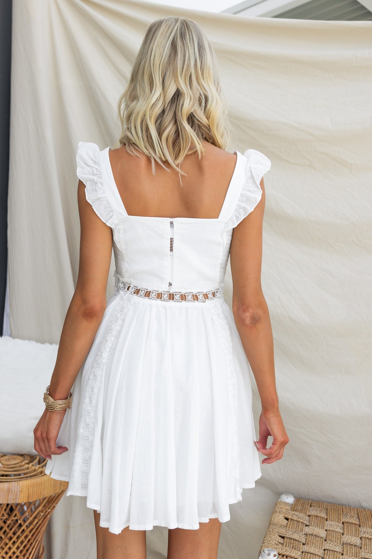 Back view of Donissa Dress featuring square neckline, ruffled sleeves, lace detailing, and cinched waist.