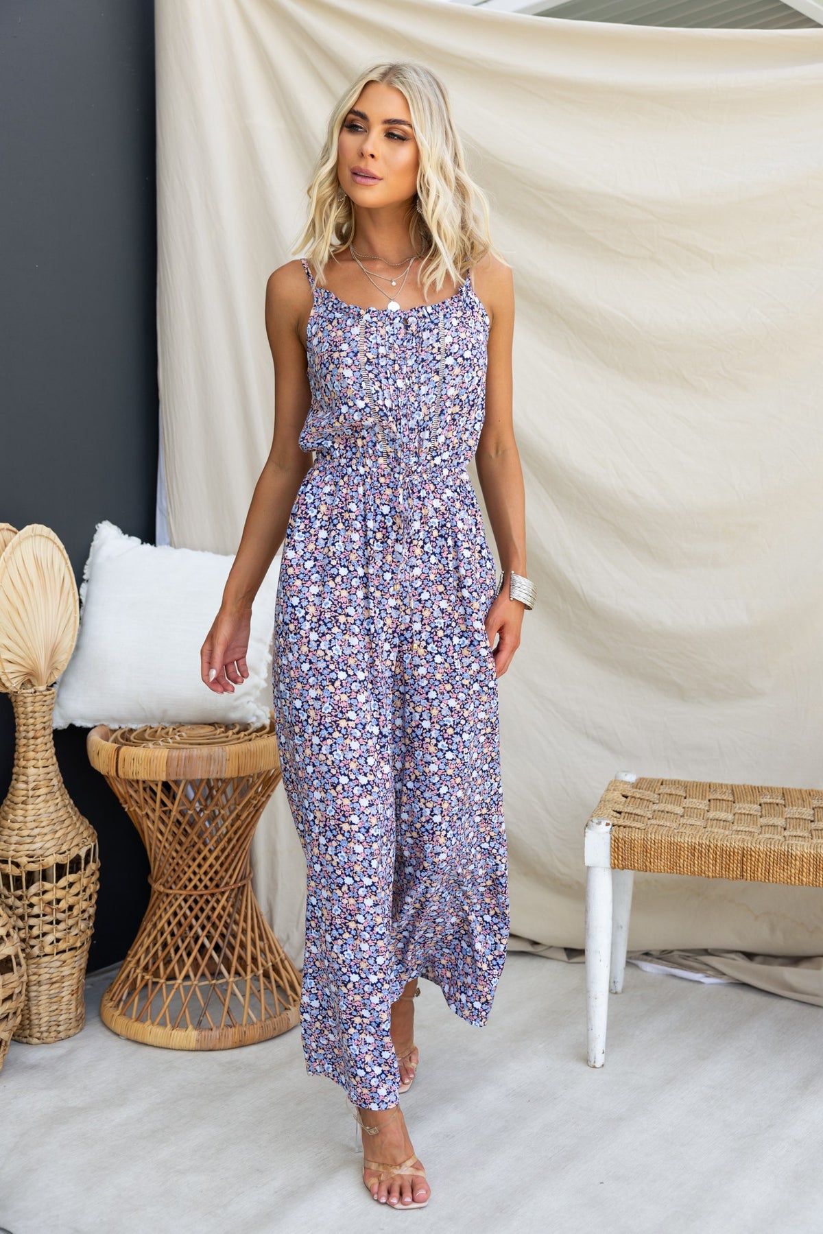 Samia jumpsuit with adjustable straps and floral print, styled against a neutral background, perfect for casual wear.