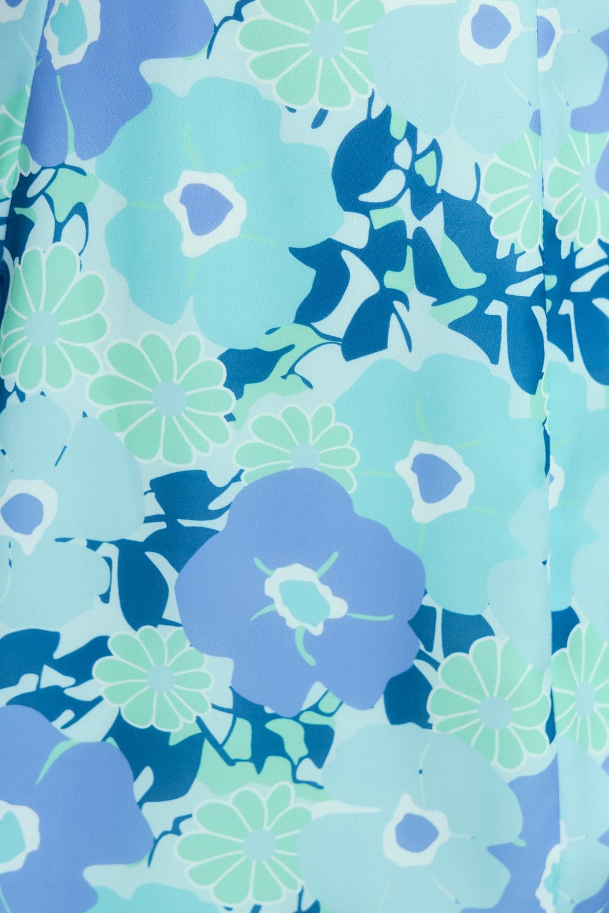 Close-up of vibrant floral pattern in shades of blue and green, perfect for a stylish dress.