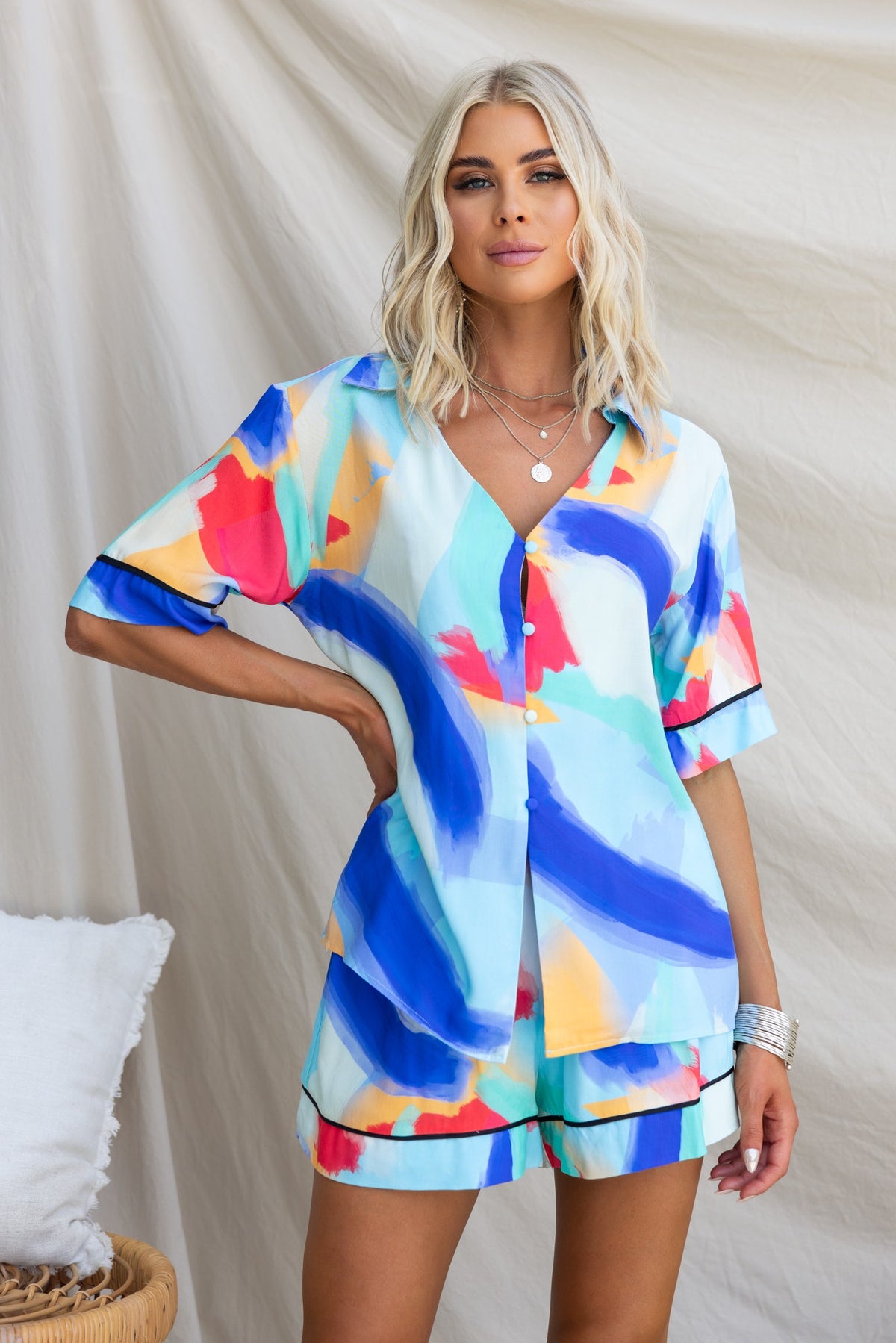 Model wearing a vibrant Focus Shirt with colorful abstract print, featuring a button-up front and relaxed fit.