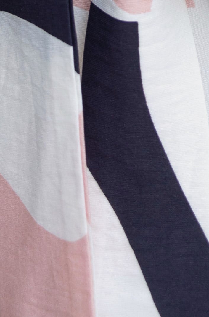 Close-up of fabric pattern featuring pink, black, and white shapes, perfect for the Otherside Midi Dress.