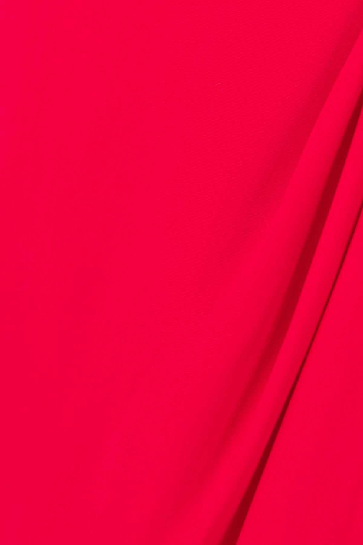 Close-up of vibrant red fabric showcasing a smooth texture, ideal for Hadas Dress with adjustable straps and stylish design.