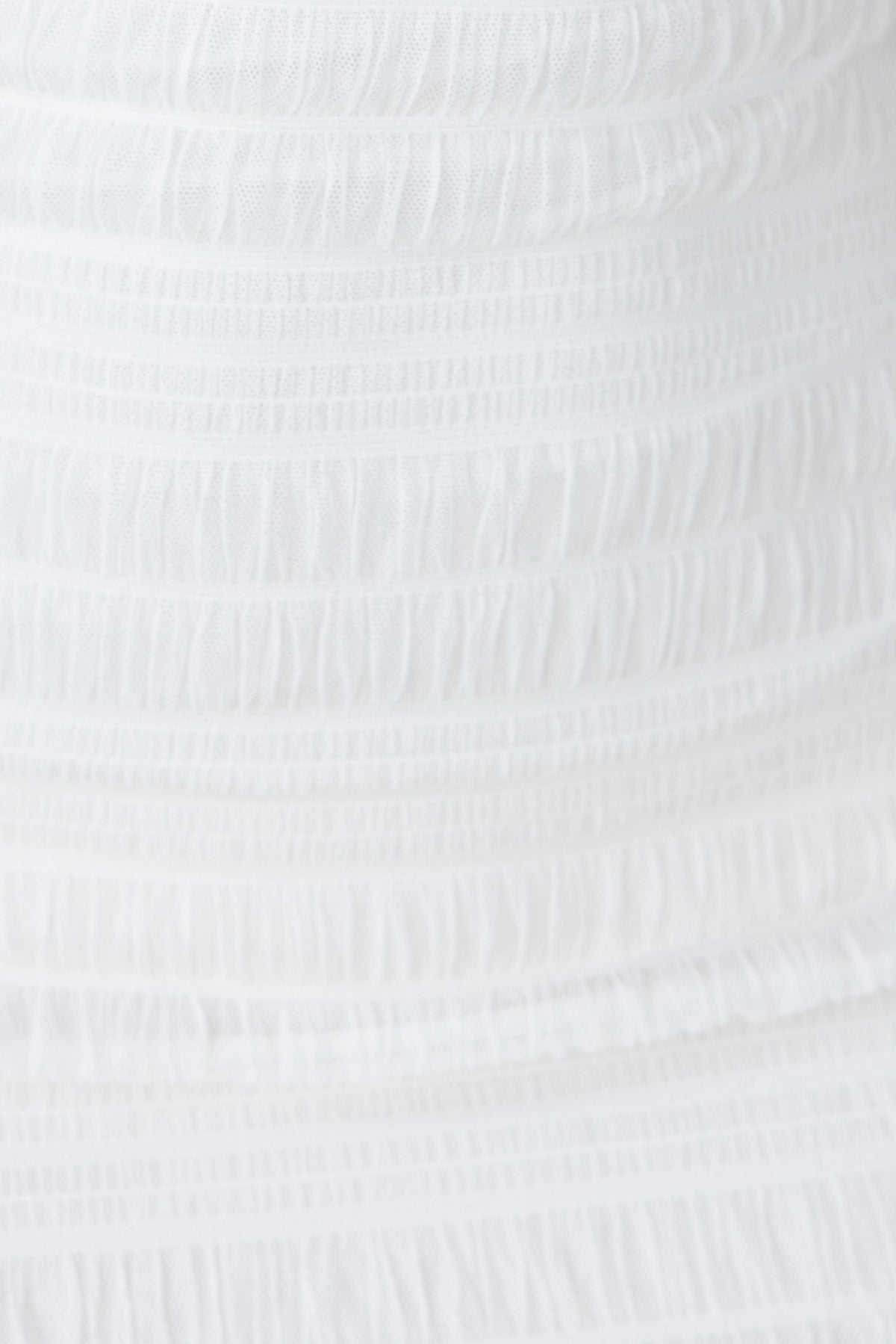 Close-up of the textured fabric of the Dimitra Dress in white, showcasing its stretch and quality material.